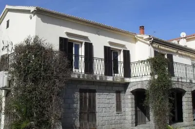a white building with a balcony on top of it at Appartement 8 pers. - Domaine de Padulone ALERIA in Aléria