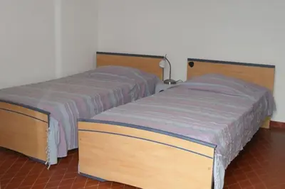 two beds sitting next to each other in a room at Appartement 8 pers. - Domaine de Padulone ALERIA in Aléria