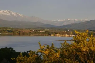 a view of a lake with mountains in the background at Appartement 8 pers. - Domaine de Padulone ALERIA in Aléria