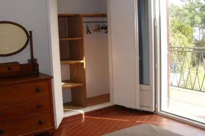 a room with a dresser and a mirror next to a door at Appartement 8 pers. - Domaine de Padulone ALERIA in Aléria