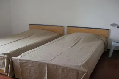 two beds sitting next to each other in a bedroom at Appartement 8 pers. - Domaine de Padulone ALERIA in Aléria