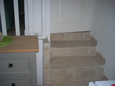 a stone staircase leading to a door in a kitchen at CHAMBRE INDEPENDANTE climatisée, cuisine d'été, piscine in Sartène
