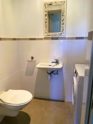 a bathroom with a toilet and a sink at Appartement Lena 6 pers piscine 500 m plage in Sainte-Lucie de Porto-Vecchio