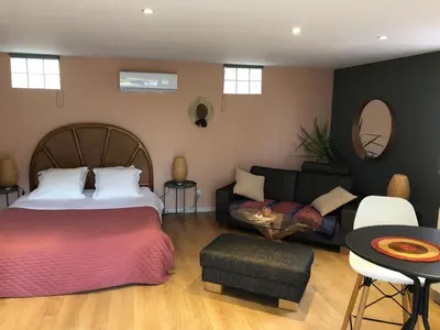 a bedroom with a bed and a couch at Casa de Patarra gîte dans le maquis avec piscine privée in Peri