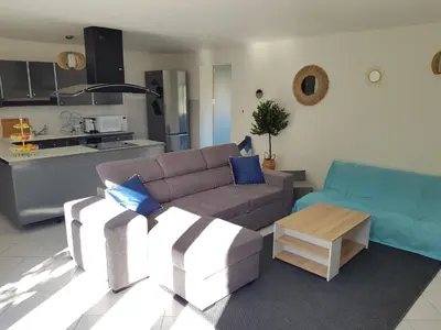 a living room with a couch and a table at PALMA Piscine chauffée Grand jardin avec piscine à 1 km de la mer in Solaro