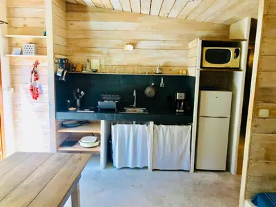 a small kitchen with a sink and a refrigerator at La rose bleue (2) in Olmeto