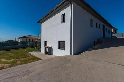 a white building with a black roof at Afa proche Ajaccio, magnifique villa avec piscine privée 8 personnes in Afa