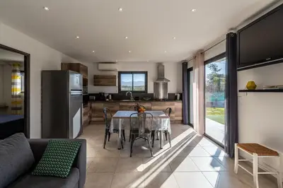 a kitchen and dining room with a table and chairs at Afa proche Ajaccio, magnifique villa avec piscine privée 8 personnes in Afa