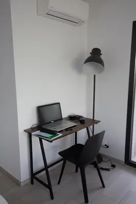 a desk with a laptop and a chair in a room at Villa MAYA in Lecci