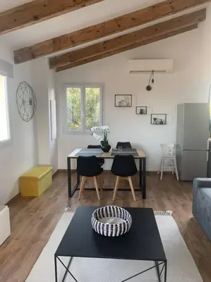 a living room with a table and a couch at Panorama exceptionnel sur les hauteurs de Propriano in Propriano