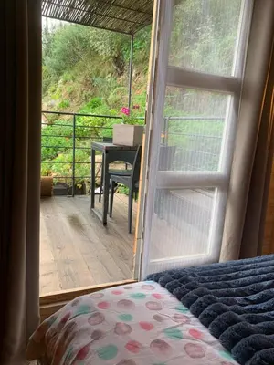 a bedroom with a bed and a balcony with a table at U Sognu 3128 in Muro