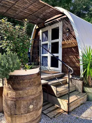 a tiny house with a porch and a barrel at U Sognu 3128 in Muro