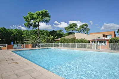a swimming pool with blue water in a yard at Apartment by Lido Beach & Biguglia Lagoon in Borgo