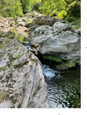 a stream of water between two large rocks at Appartement tout confort 2-4 pers 500 m de la plage avec piscine et wifi in Santa-Maria-Poggio