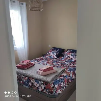 a bedroom with a bed with pink towels on it at Grand studio classé 3 etoiles in Tavera