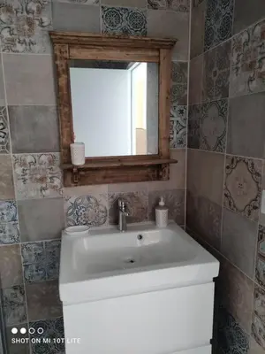 a bathroom with a white sink and a mirror at Grand studio classé 3 etoiles in Tavera