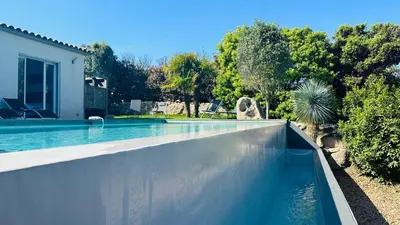a view of trees and a swimming pool at night at Villa Porto-vecchio 4 chambres avec piscine in Porto-Vecchio