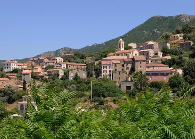 a village on top of a hill with houses at Petit coin de paradis, vue panoramique mer &montagne, piscine privée... in Calcatoggio
