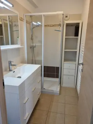 a bathroom with a white sink and a shower at Résidence Saint Florent Oletta in Saint-Florent