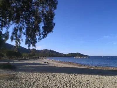a beach with people on it and the water at Résidence Saint Florent Oletta in Saint-Florent