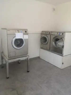 a laundry room with a washer and a washing machine at Résidence Saint Florent Oletta in Saint-Florent