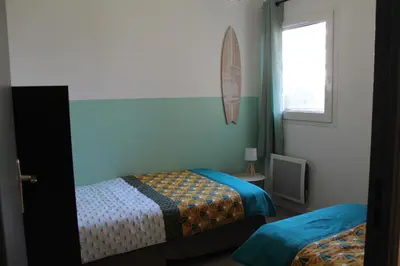 a bedroom with two beds and a window at Location Ajaccio in Ajaccio