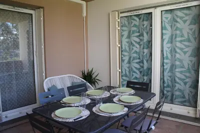 a dining room table with plates and glasses on it at Location Ajaccio in Ajaccio