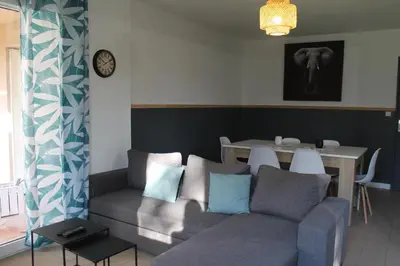 a living room with a couch and a table at Location Ajaccio in Ajaccio