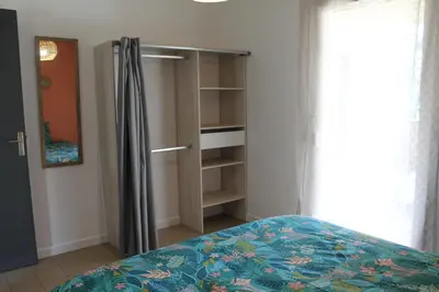 a bedroom with a bed and a book shelf at Location Ajaccio in Ajaccio