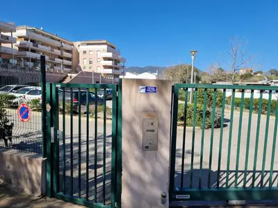 an open gate with an electrical box on it at Studio Climatisé Parking Gratuit in Sarrola-Carcopino