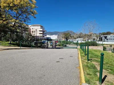 an empty street with a fence on the side of the road at Studio Climatisé Parking Gratuit in Sarrola-Carcopino