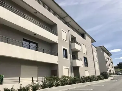an apartment building with balconies on a street at 2 pièces vue mer à 3 min des plages in Propriano