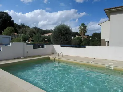 a swimming pool in the backyard of a house at Residence Amanda in Santa-Lucia-di-Moriani