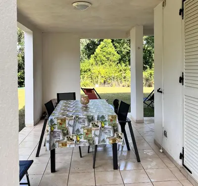 a table and chairs on a patio with a view at Residence Amanda in Santa-Lucia-di-Moriani