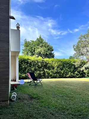 a chair sitting in the yard of a house at Residence Amanda in Santa-Lucia-di-Moriani