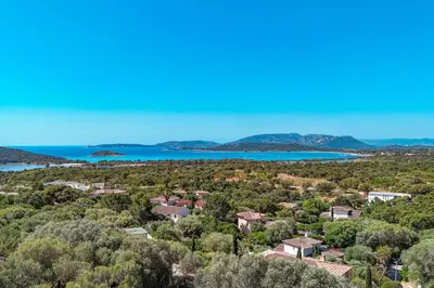 an aerial view of a town with trees and a lake at Villa Casta Joia Di Cirendinu in Sainte-Lucie de Porto-Vecchio