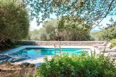 a swimming pool in the middle of a garden at Villa Casta Joia Di Cirendinu in Sainte-Lucie de Porto-Vecchio