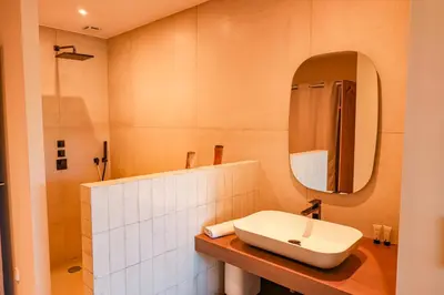 a bathroom with a sink and a mirror at Villa Casta Joia Di Cirendinu in Sainte-Lucie de Porto-Vecchio
