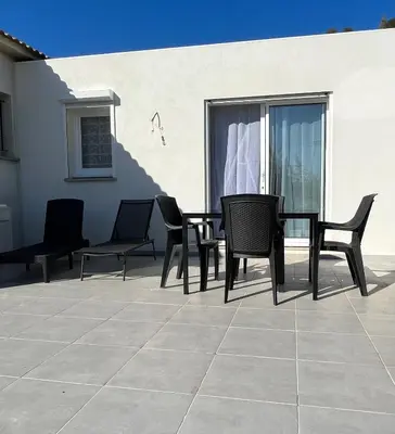 a group of chairs and a table on a patio at Maison T1 bis Corse in Lucciana