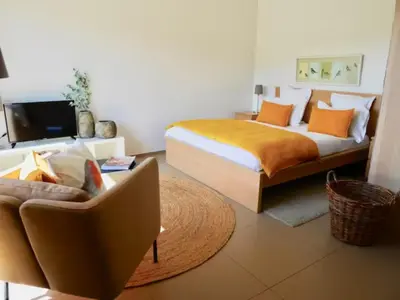 a bedroom with a bed and a couch at Studio 33m² vue mer in Propriano