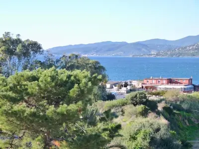 a view of a body of water with a house and trees at Studio 33m² vue mer in Propriano