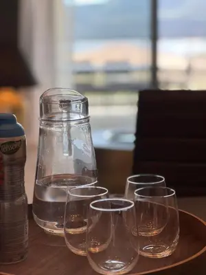 a group of wine glasses sitting on a table with a jar at BEL'ORIZONTE B , proche centre ville et plage in Propriano