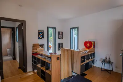 a room with a wooden shelf with wine bottles at Villa Terra Bella hauteur de la ville avec piscine et vue mer in Propriano