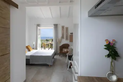 a bedroom with a bed and a balcony at Costa Marina in Porto-Vecchio