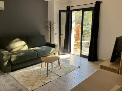 a living room with a green couch and a table at T2 Rocca in Sotta
