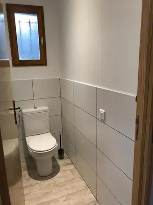 a bathroom with a white toilet and a window at T2 Rocca in Sotta