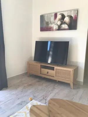 a flat screen tv sitting on a stand in a living room at T2 Rocca in Sotta