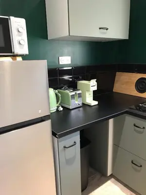 a kitchen with a black counter with appliances on it at T2 Rocca in Sotta