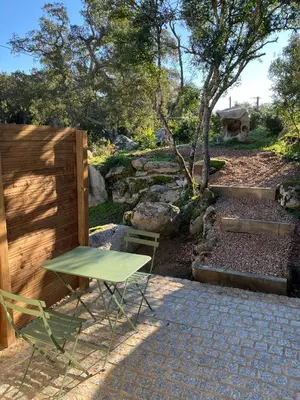 a green table and chair sitting on a patio at T2 Rocca in Sotta