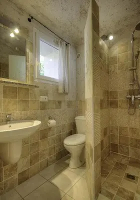 a bathroom with a toilet and a sink at CORSACASA Villa in Palombaggia sea view in Porto-Vecchio